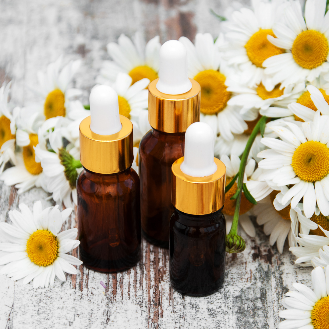 Essential oil bottles with chamomile flowers