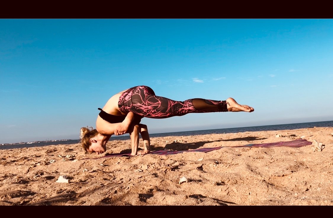Arm balance on the beach
